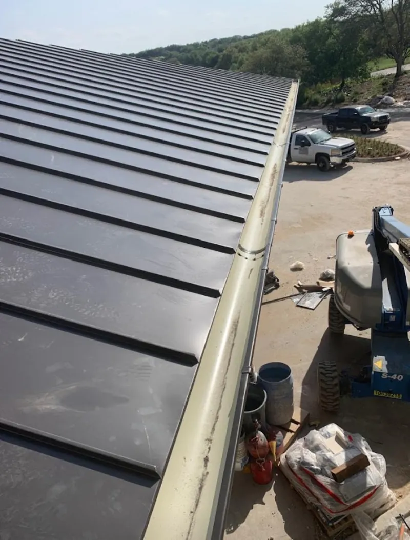 Standing seam panel and gutter detail on a metal roofing jobsite in Honey Brook